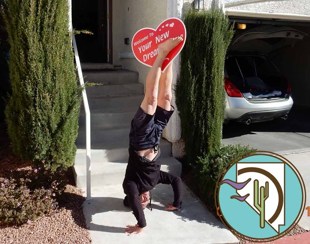 Super stoked homebuyer does headstand with Welcome to your new home sign!